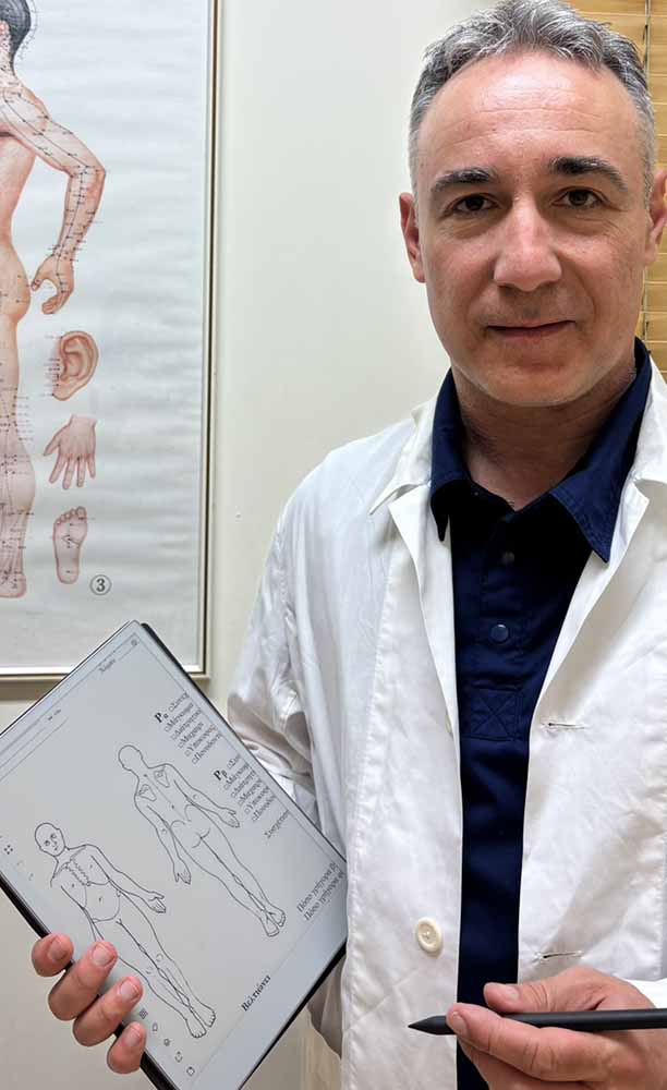 Dr Danalis taking medical history from a patient